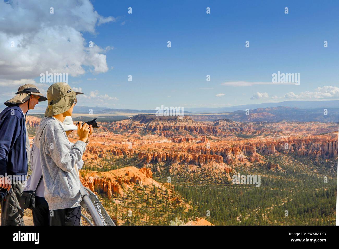 Tourists enjoying the breathtaking panoramic view of Bryce Canyon National Park with its unique rock formations and vast landscape. Stock Photo