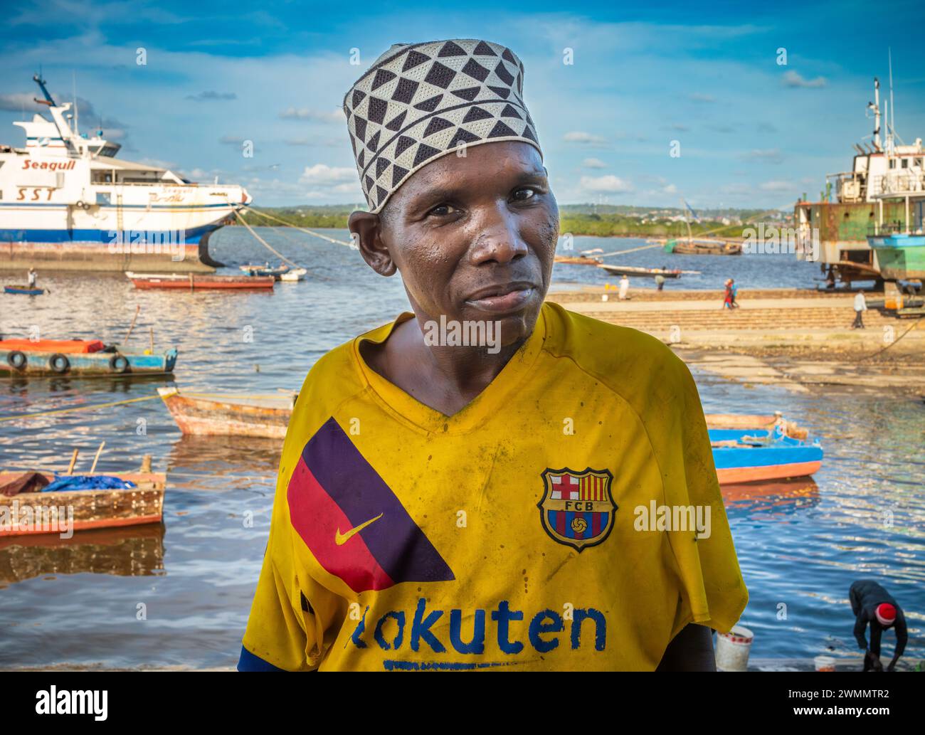 A fisherman on the quayside at Darajani Market, or the fish market, in Stone Town, Zanzibar, Tanzania. Stock Photo