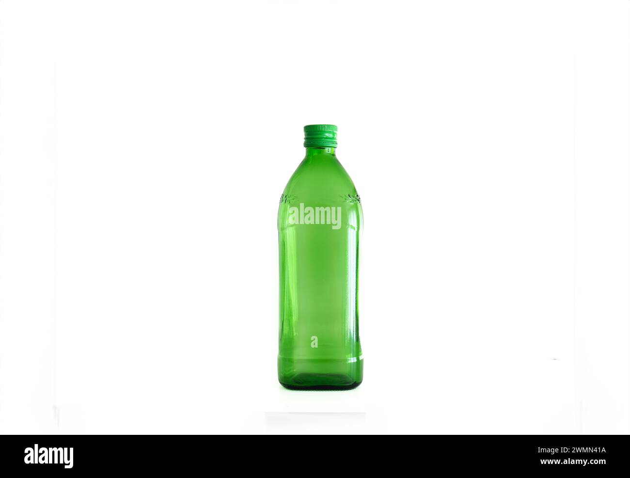 Large green empty glass bottle isolated on white. Stock Photo