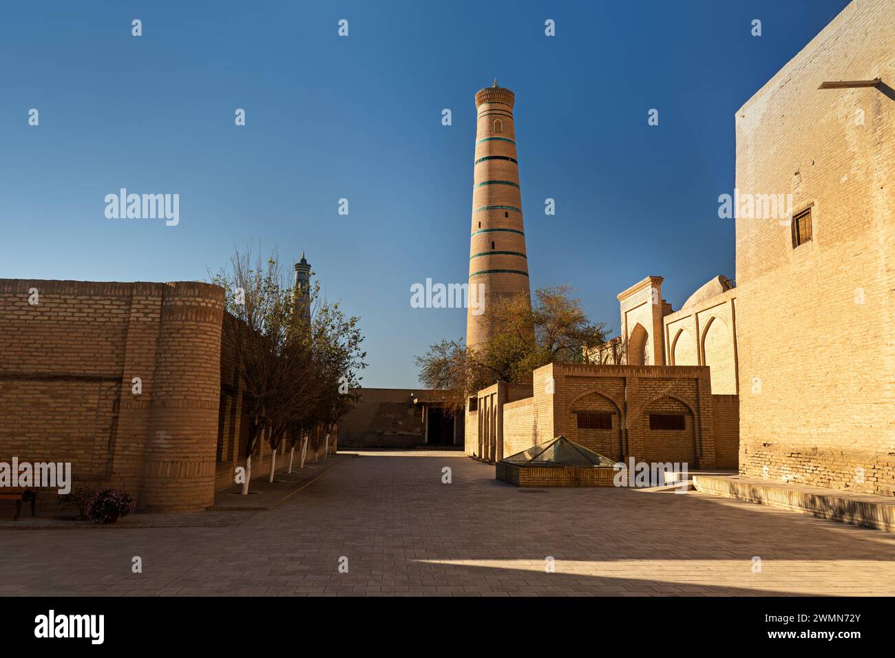 Juma mosque minaret in Khiva. Uzbekistan. an empty street of an ancient medieval city Itchan Kala, Khiva, Khorezm region, Uzbekistan Stock Photo