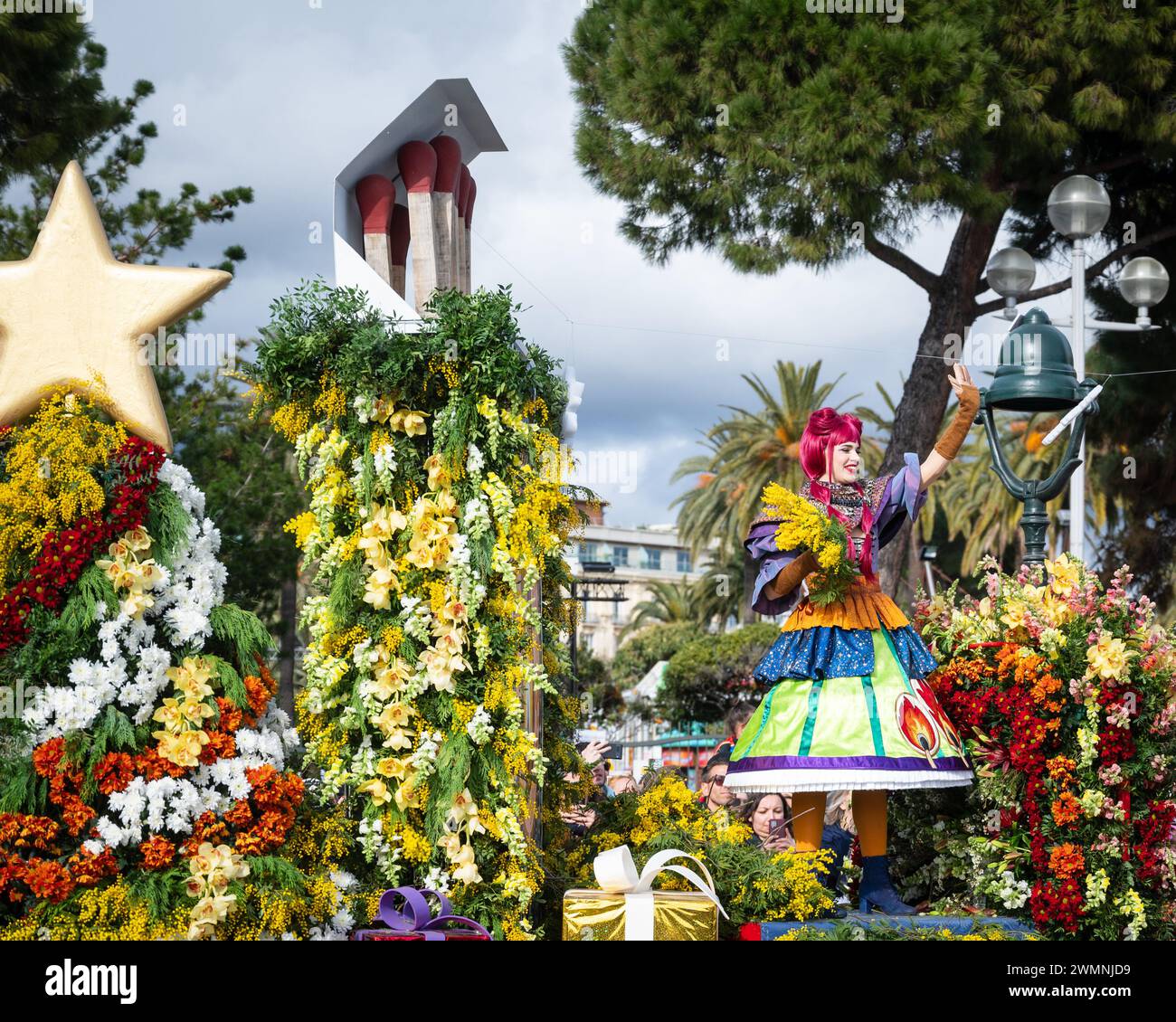 Women on Carnival floats throw flowers to the crowds at Nice Carnival Flower Battle -24 February 2024 Stock Photo