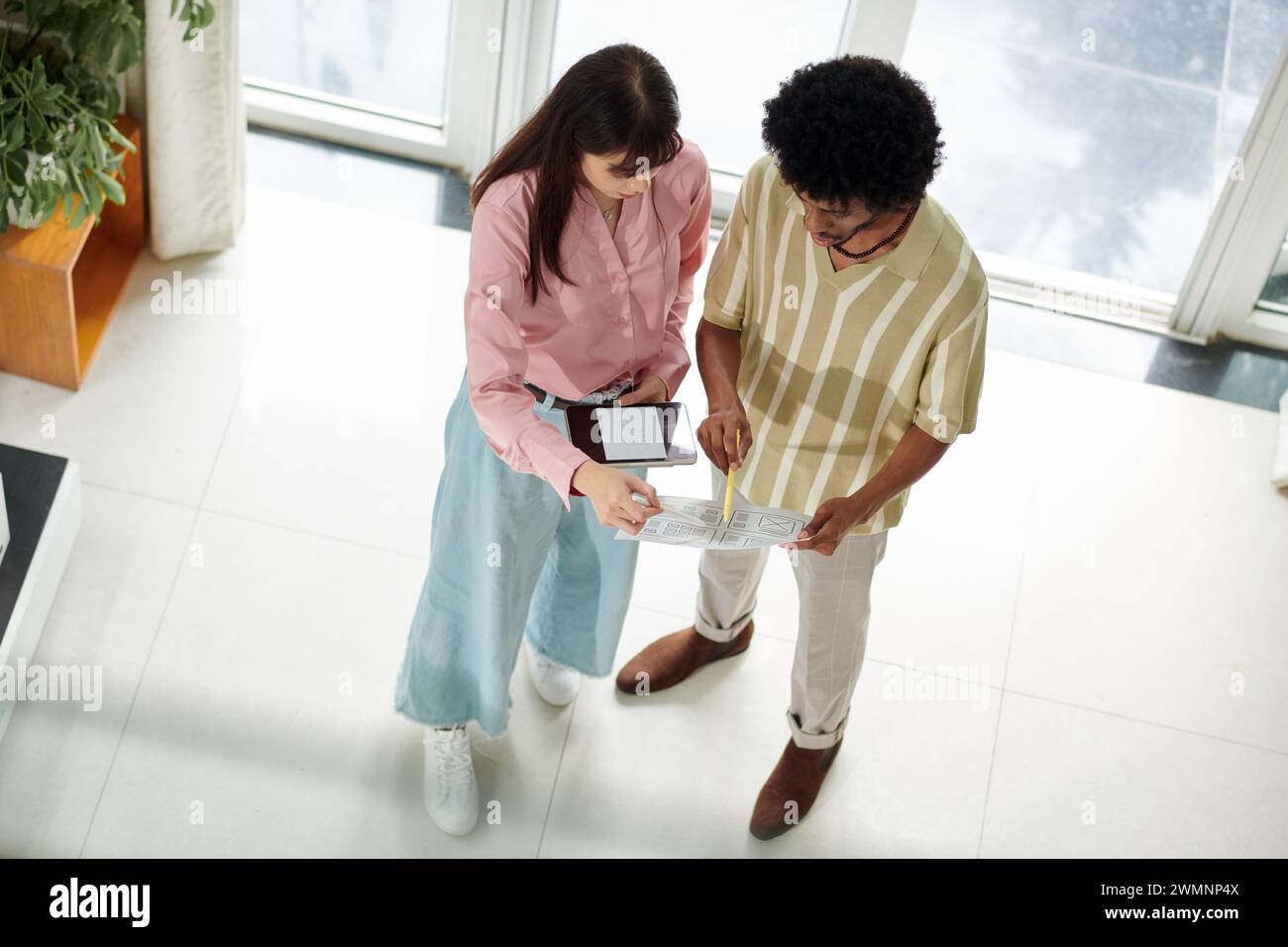 UI designer and developer discussing mobile application updates Stock Photo