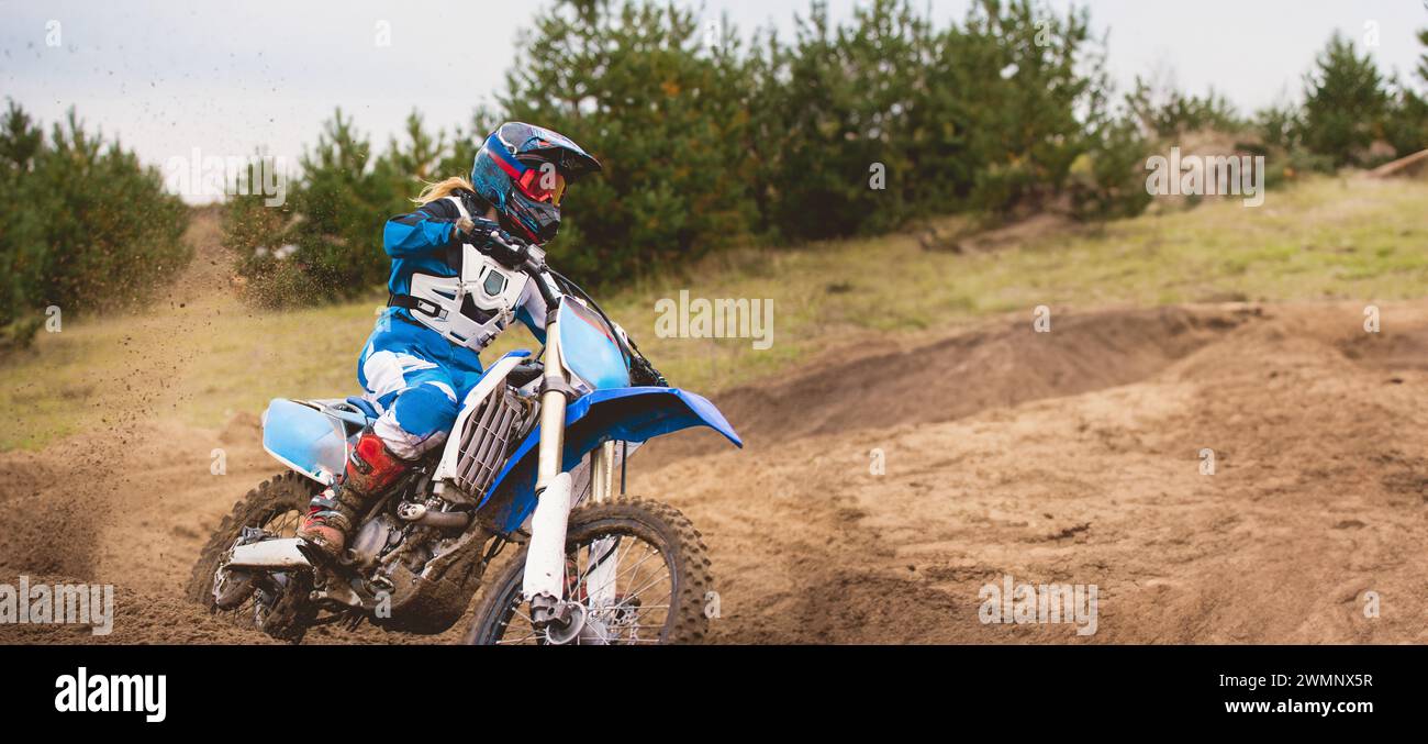 24 september 2016 - Volgsk, Russia, MX moto cross racing - Girl Bike Rider rides on a motorcycle and throwing a spray of dirt, close up Stock Photo