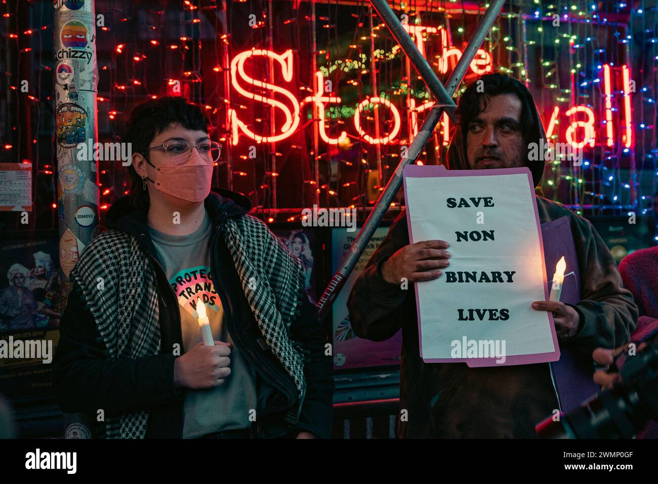 People hold a vigil outside The Stonewall Inn to mourn the death of ...
