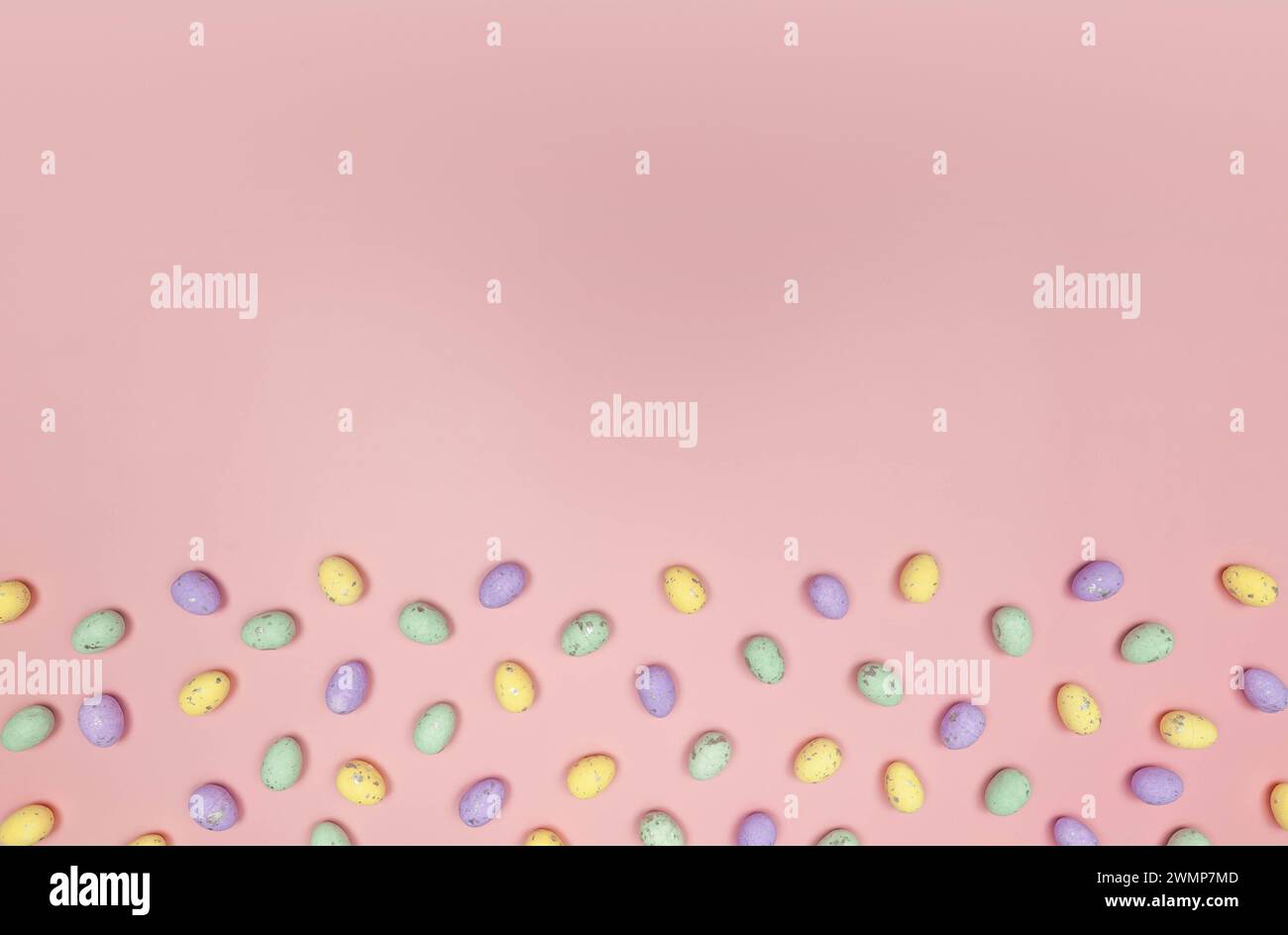 Top view of colourful easter eggs on pink background. Creative easter composition, spring, copy space, flat lay. Stock Photo