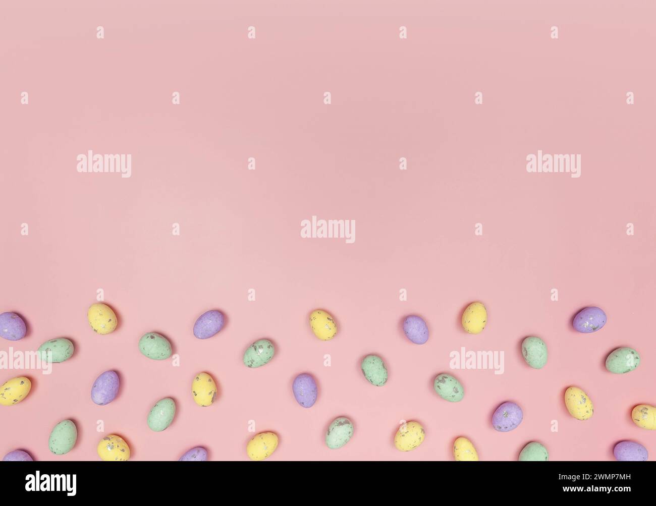 Top view of colourful easter eggs on pink background. Creative easter composition, spring, copy space, flat lay. Stock Photo
