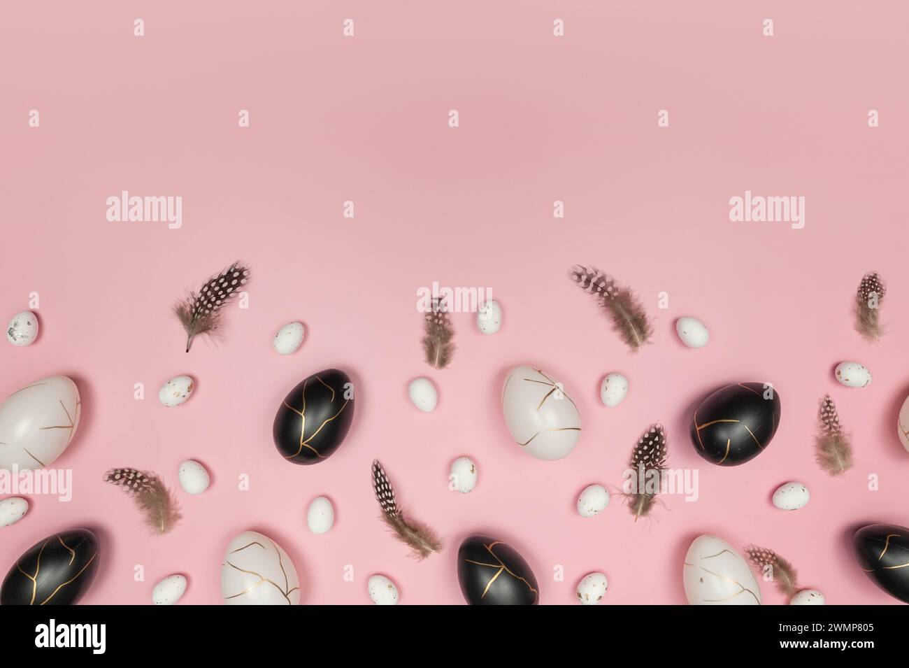 Top view of easter eggs, feathers on pink background. Creative easter composition, spring, flat lay, copy space. Stock Photo