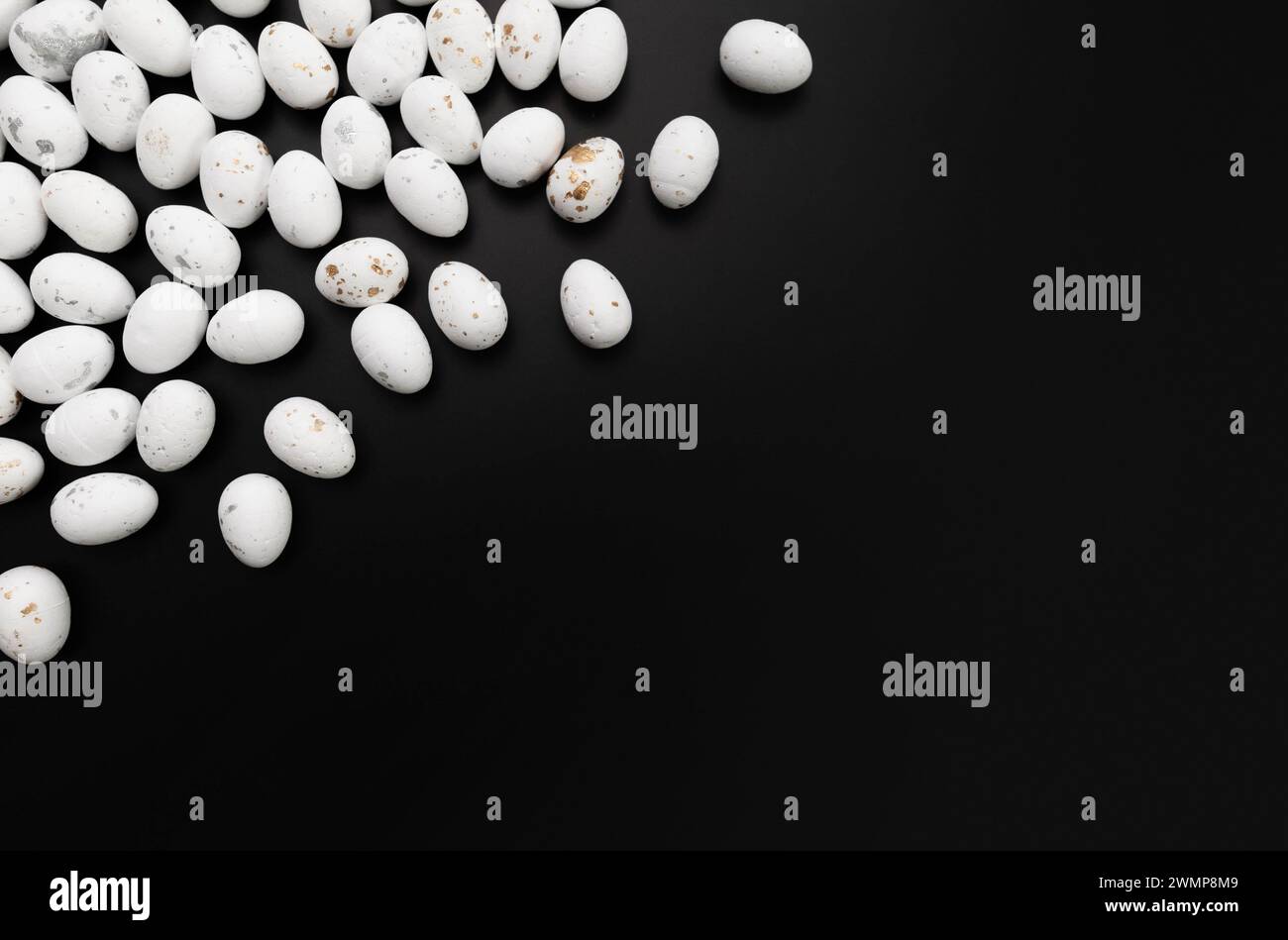 Top view of white easter eggs on black background. Creative easter composition, spring, copy space, flat lay. Stock Photo