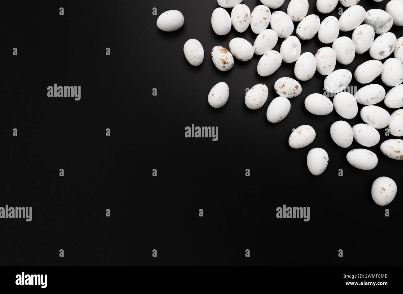 Top view of white easter eggs on black background. Creative easter composition, spring, copy space, flat lay. Stock Photo