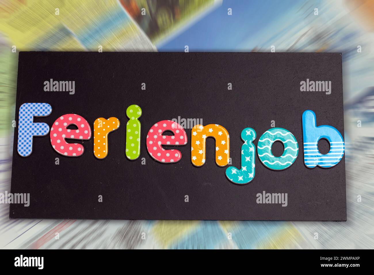 Symbol image of a holiday job: board with the german inscription FERIENJOB in front of the job adverts in a newspaper Stock Photo