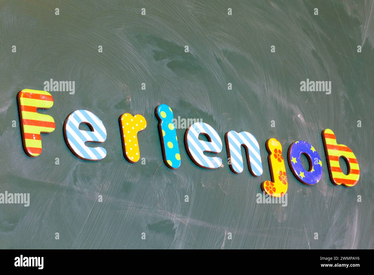 Symbol image of a holiday job: (School) board with the german inscription FERIENJOB Stock Photo