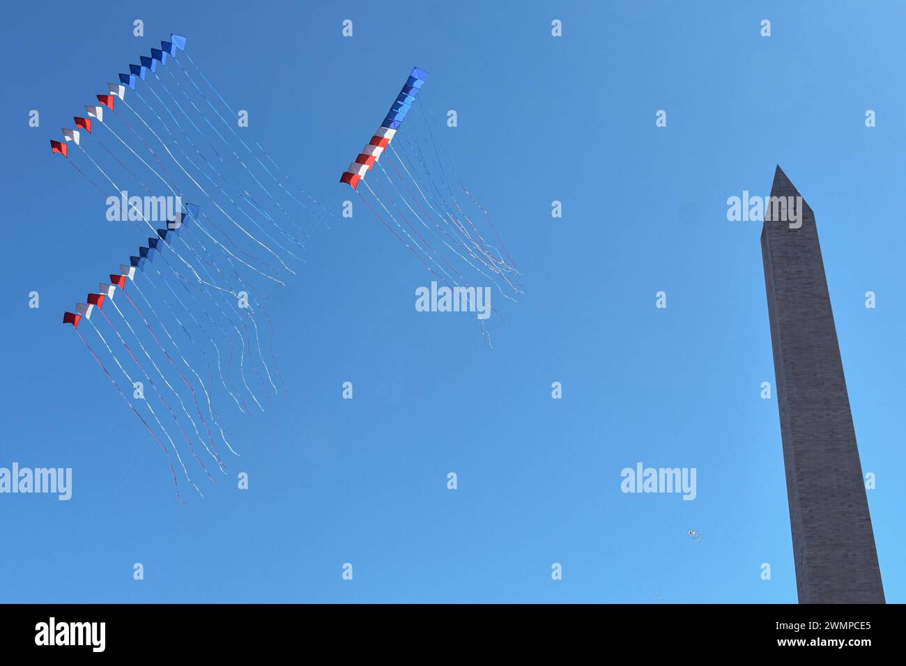 Box kites fly above the Washington Monument in annual kite festival. 26 Mar. 2023 Stock Photo