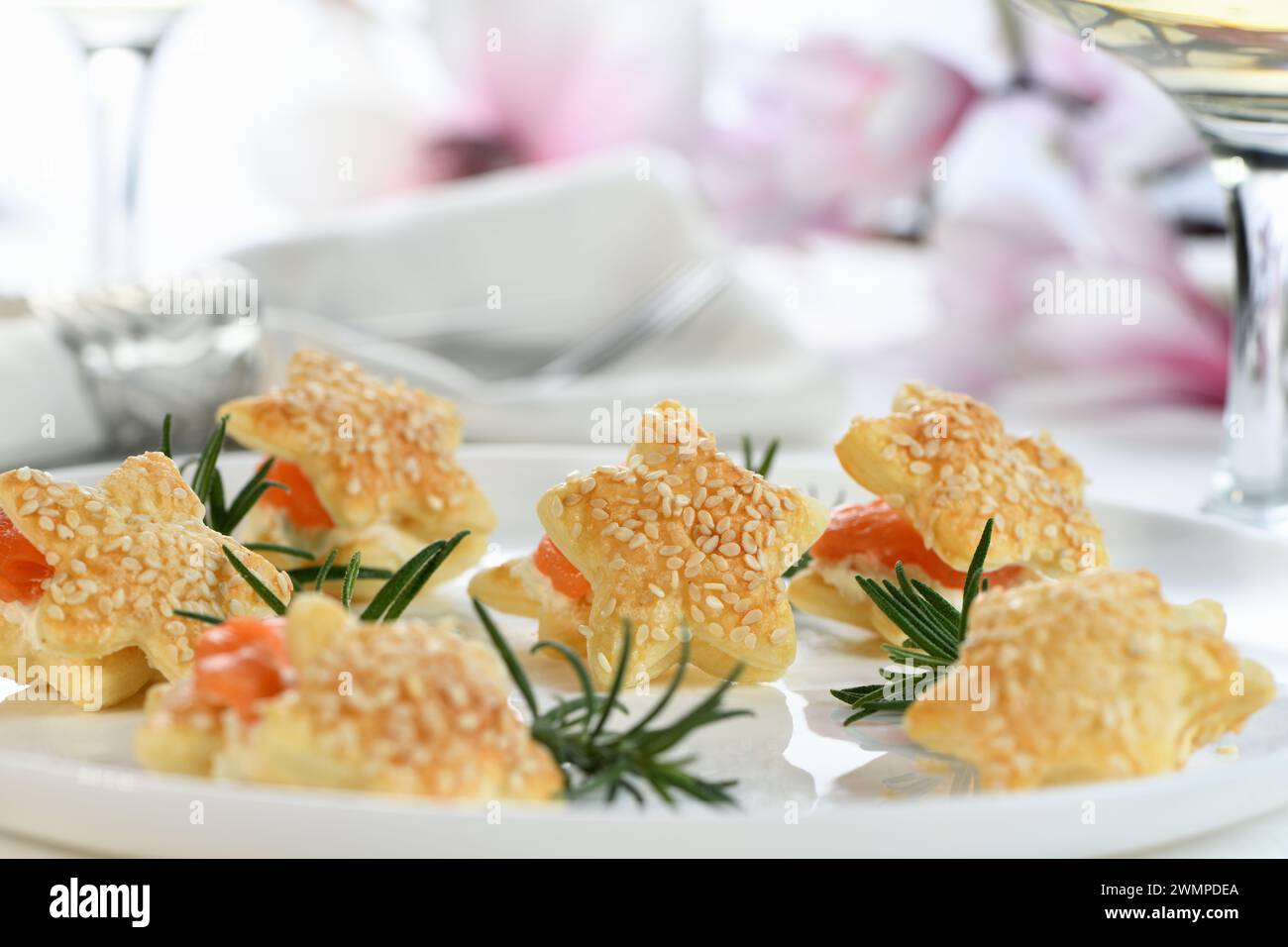 Festive appetizer of puff pastry in the shape of a star, stuffed with salmon and soft cheese. The perfect appetizer for your holiday table. Stock Photo