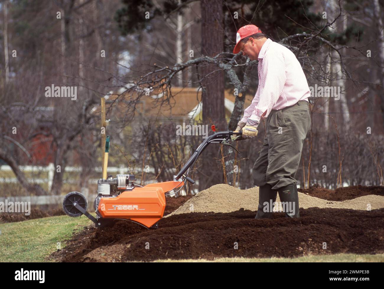 Man with rotary cultivator Stock Photo