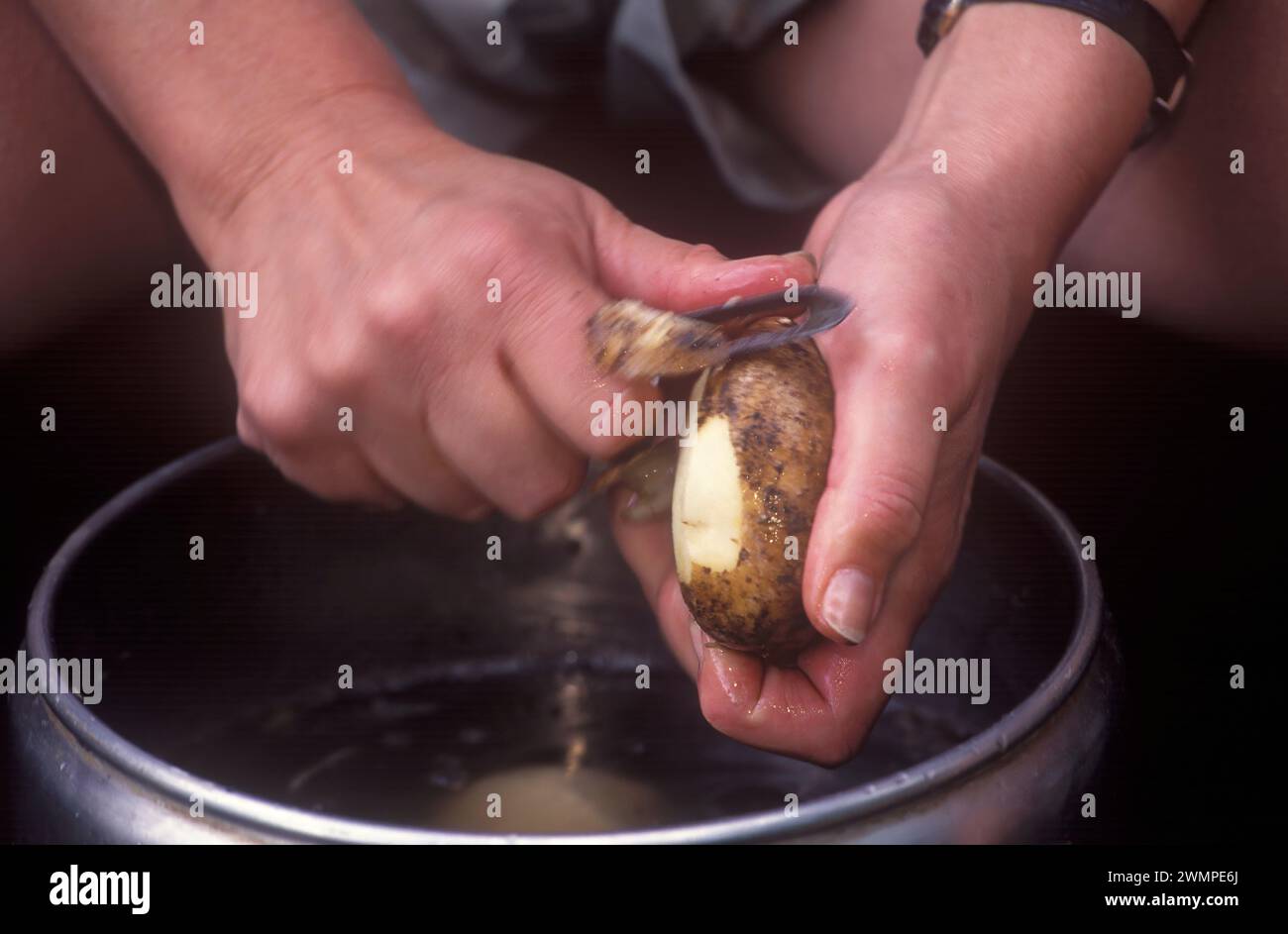 Peeling potatoes Stock Photo