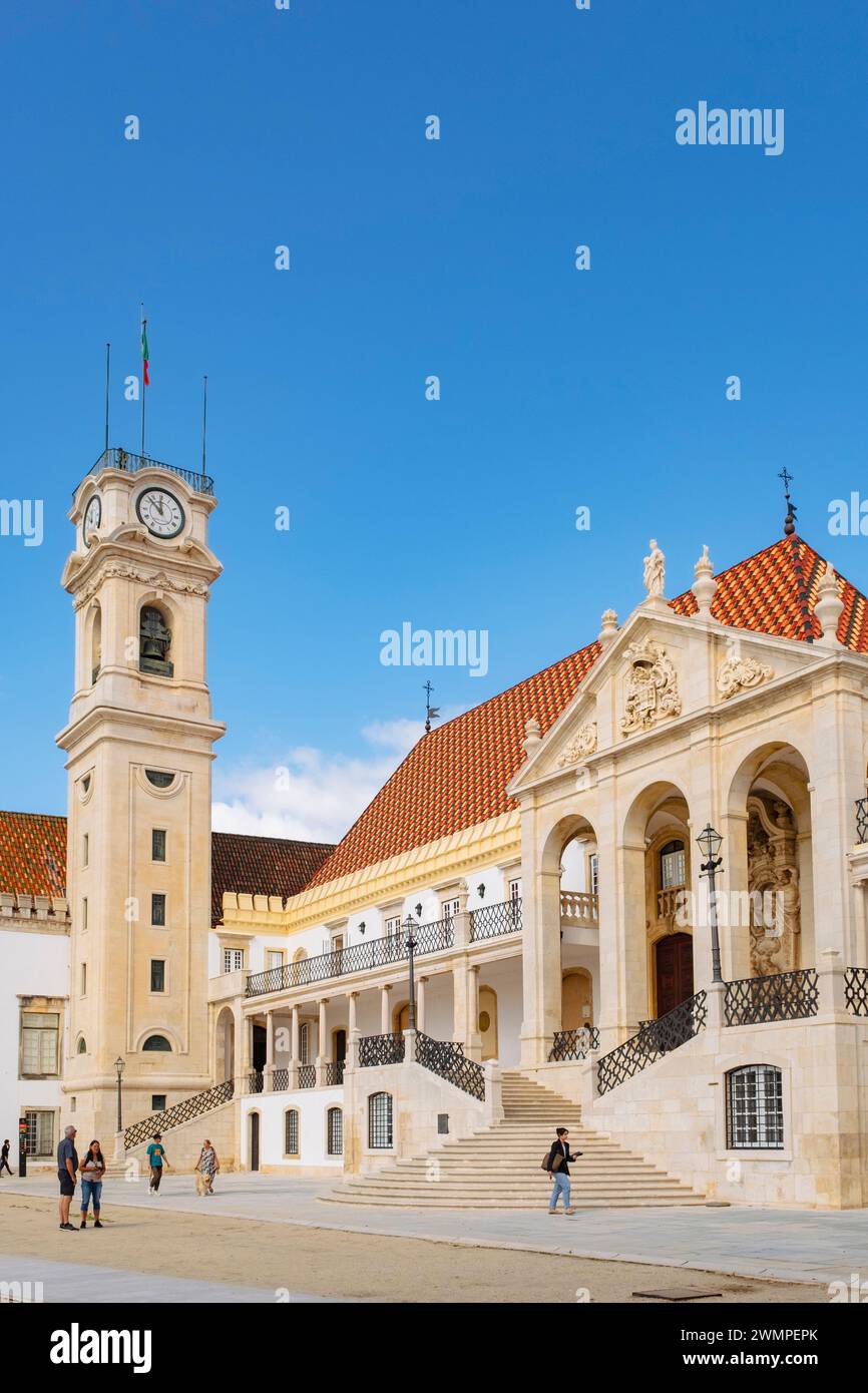 Tourists visiting University of Coimbra courtyard and clock tower. Coimbra, Portugal, Europe. A UNESCO world heritage site Stock Photo