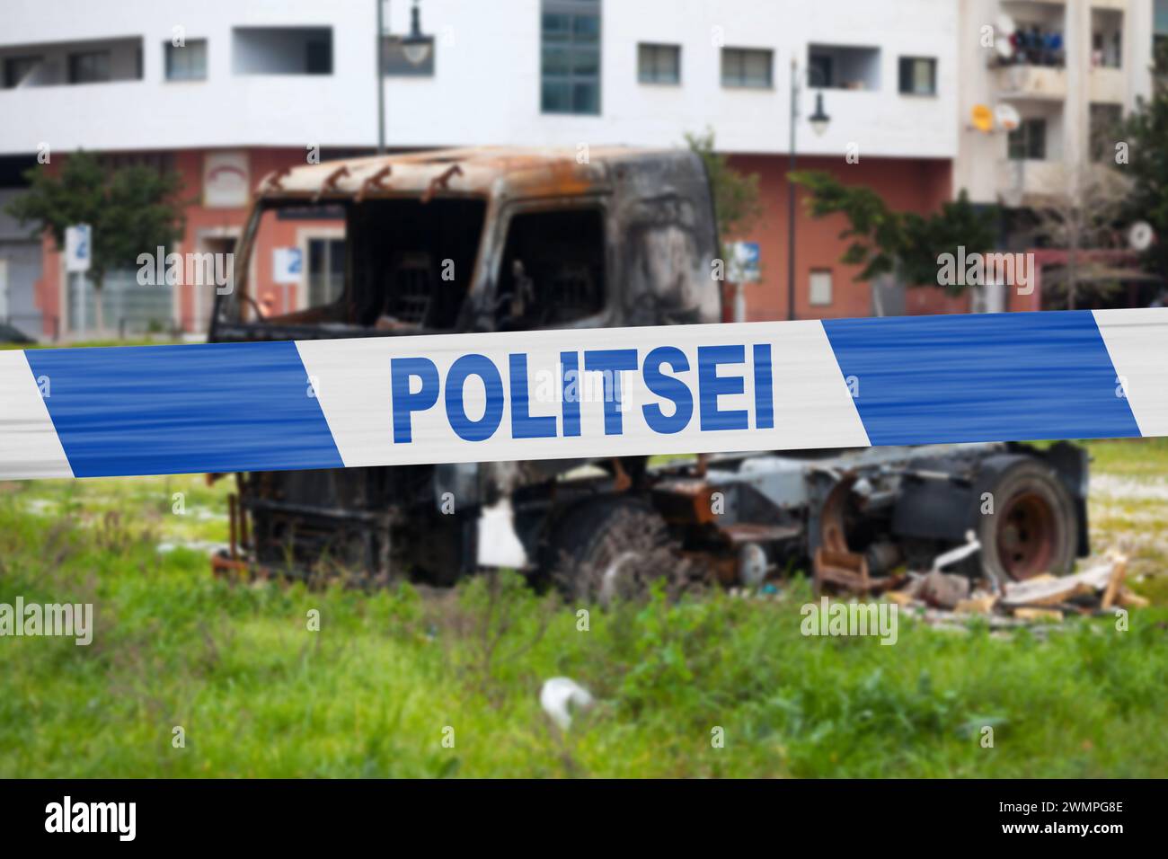 Truck burnt by a pyromaniac with a police tape with written in it in Estonian 'POLITSEI'. Stock Photo