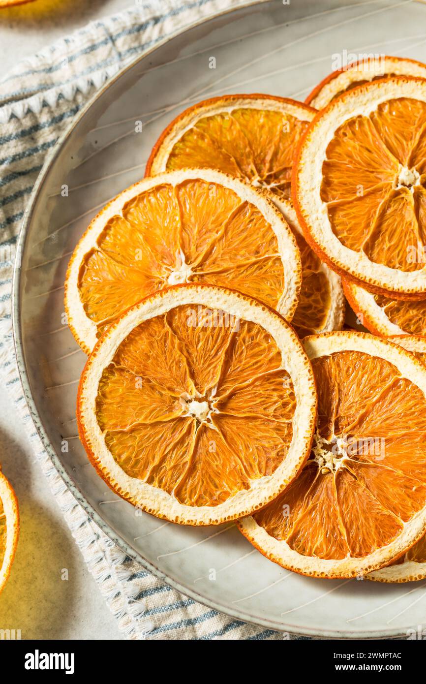 Healthy Organic Dried Dehydrated Orange Slices in a Bowl Stock Photo