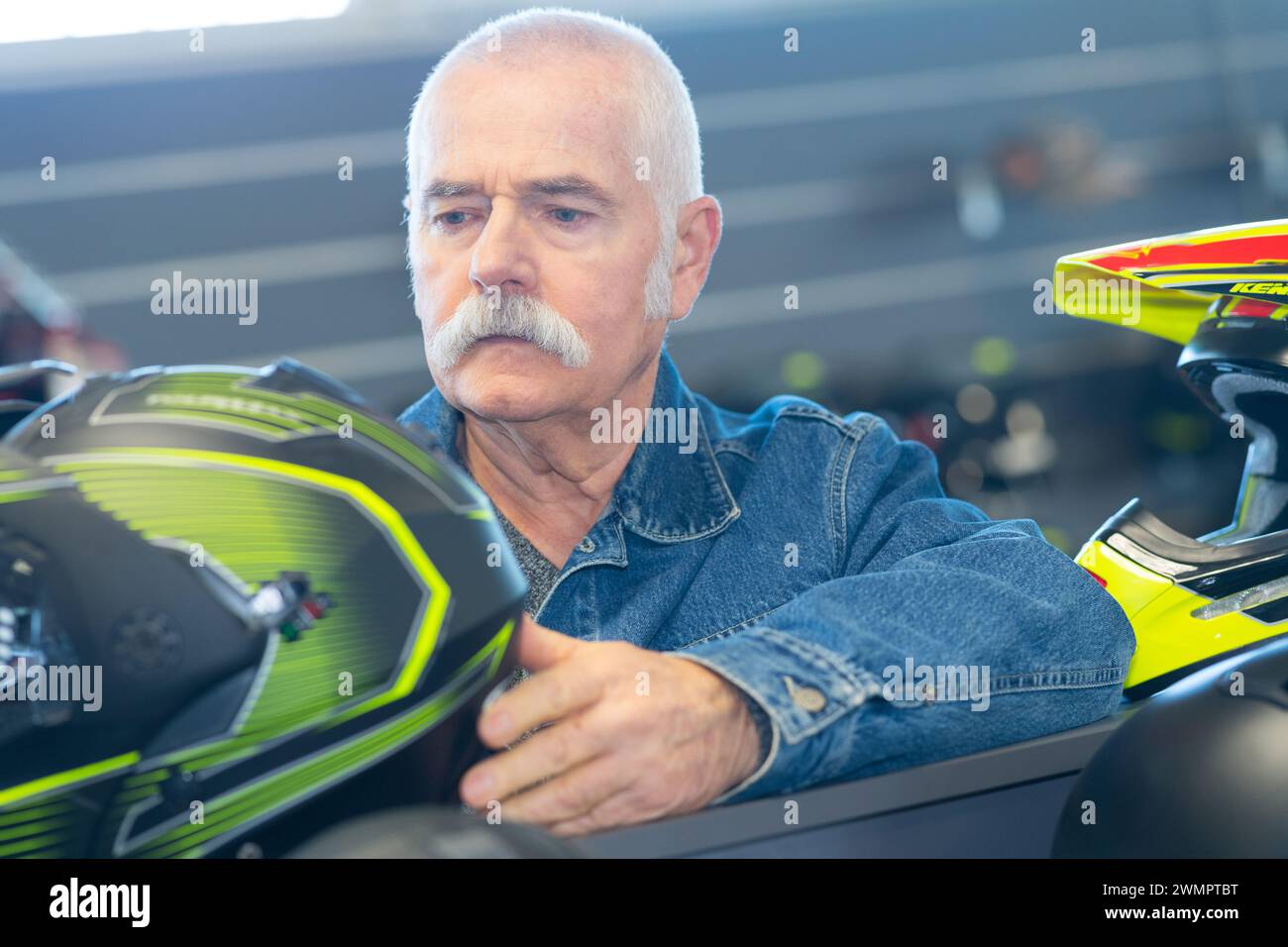 senior man choosing crash helmet Stock Photo