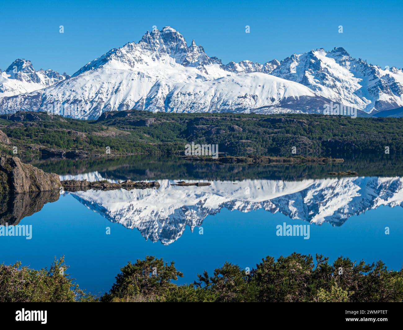 The snow-covered Mt. Cerro Castillo is reflected in a lake, Patagonia, Chile Stock Photo