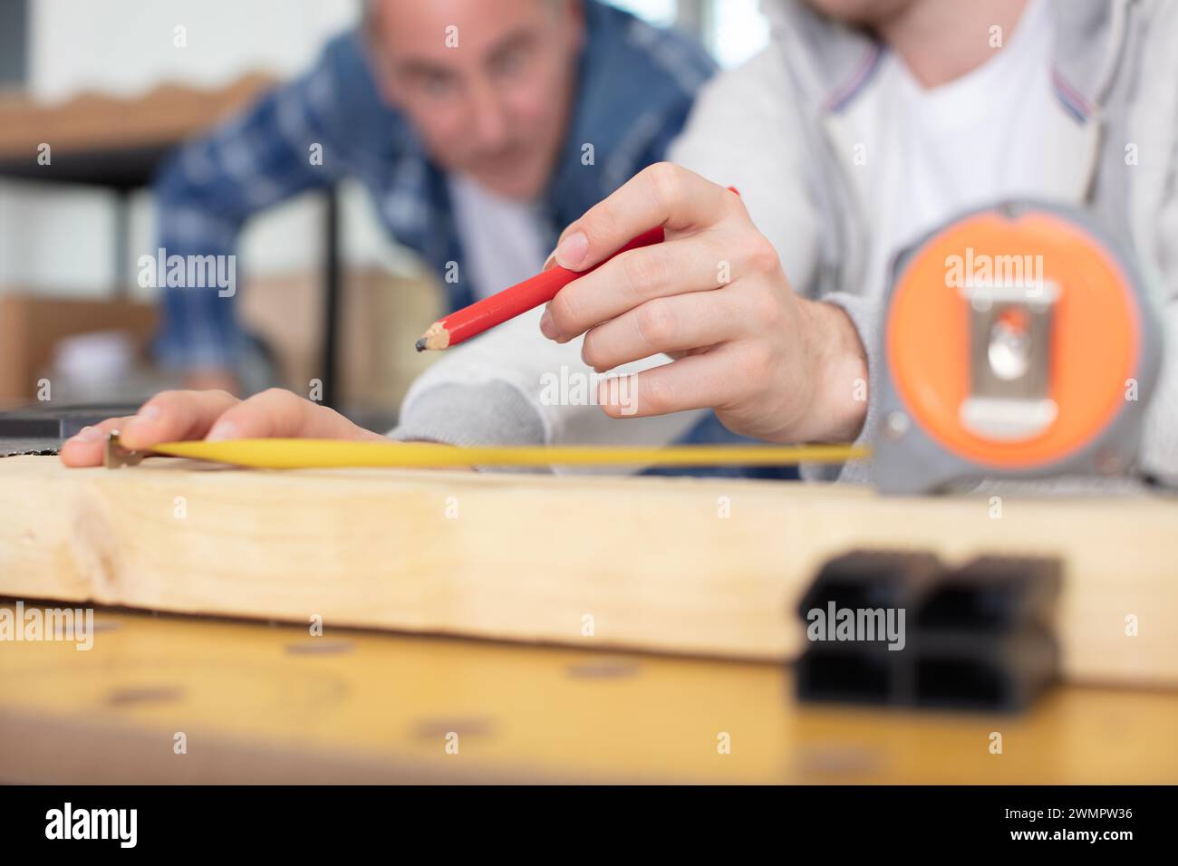 cropped view od supervisor watching apprentice mark wood Stock Photo