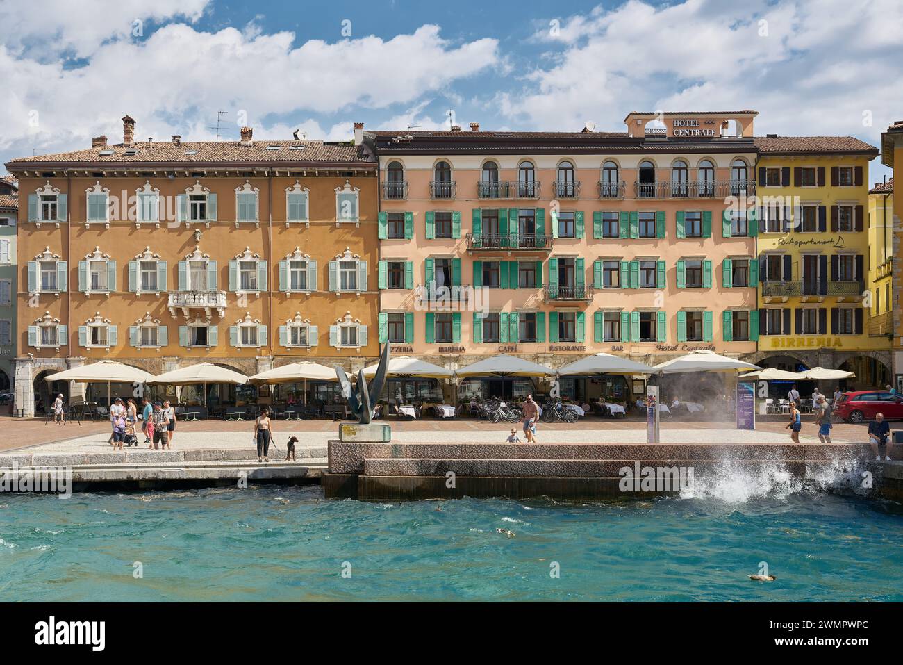 Hotels and restaurants on the shores of Lake Garda on Piazza III Novembre in the popular town of Riva del Garda in Italy in summer Stock Photo
