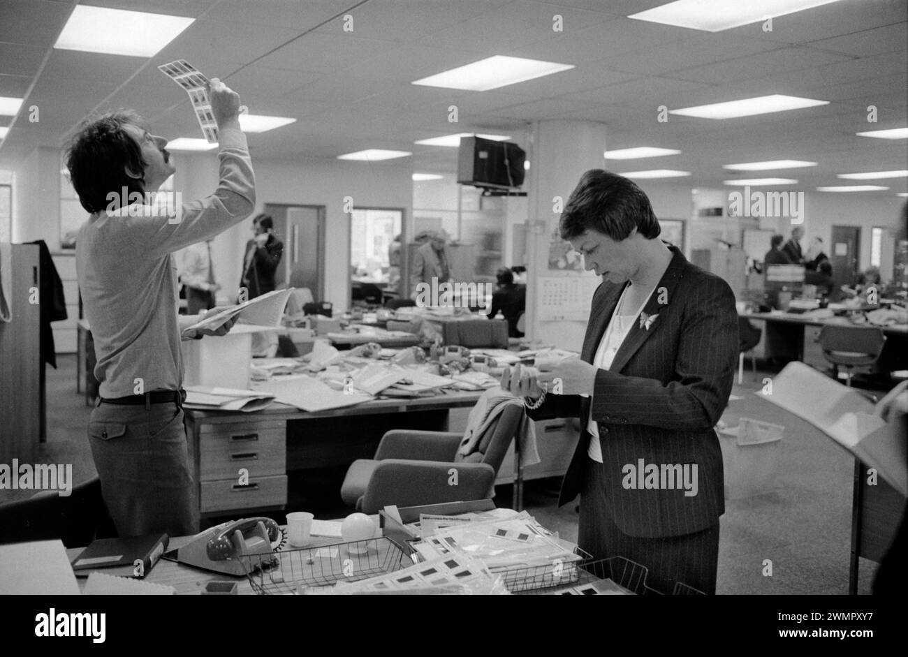 London, England 28th of April 1981. Now! magazine closes down, June Stanier and Colin Jacobson picture editors, looking at a sheet of colour transparencies, checking for the best image.  Sir James Goldsmith closed down his weekly news magazine Now! due to unprofitable trading on Monday 27th April 1981. HOMER SYKES Stock Photo