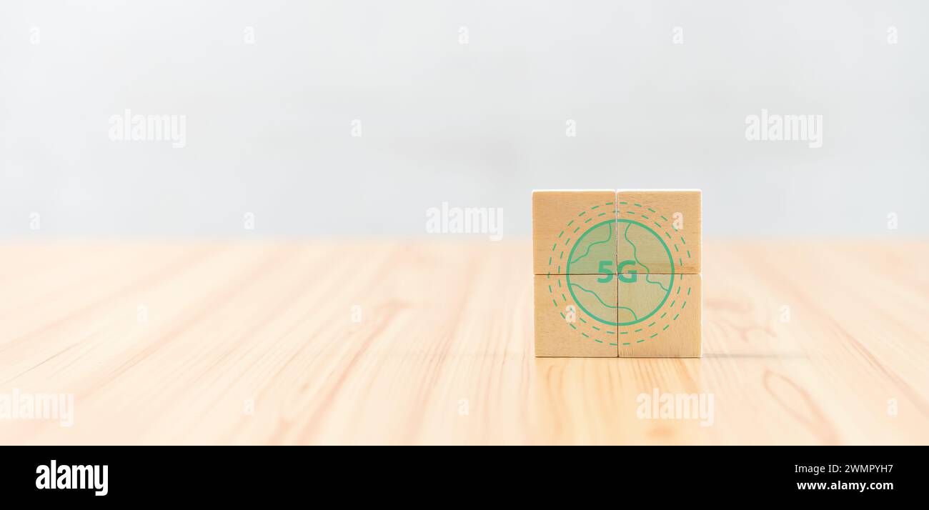 A cube on a wooden table with a globe image Stock Photo