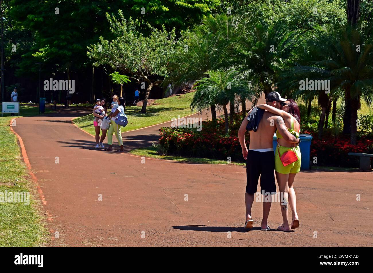 RIBEIRAO PRETO, SAO PAULO, BRAZIL - December 28, 2023: Couple kissing and walking on public park Stock Photo