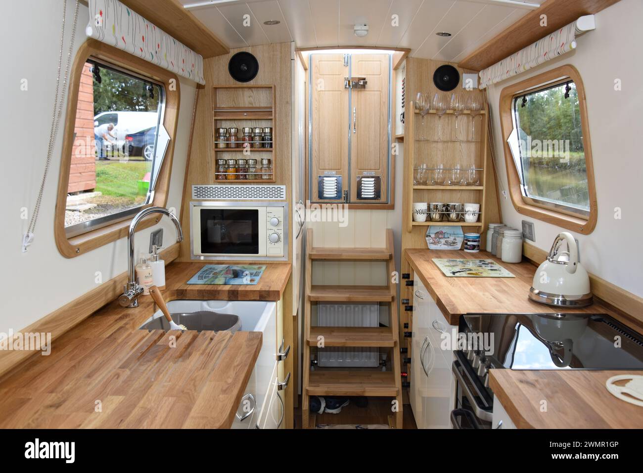 Walk through galley of a narrowboat with kitchen appliances in situ. Stock Photo