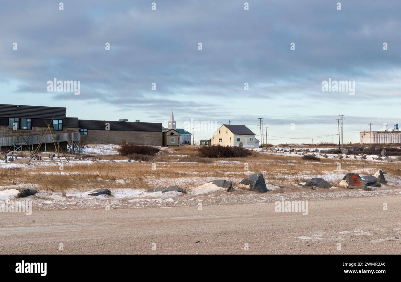 Wide view of the town of Churchill, Manitoba with the community centre, church, and grain elevator in soft morning light on a cold November day. Stock Photo