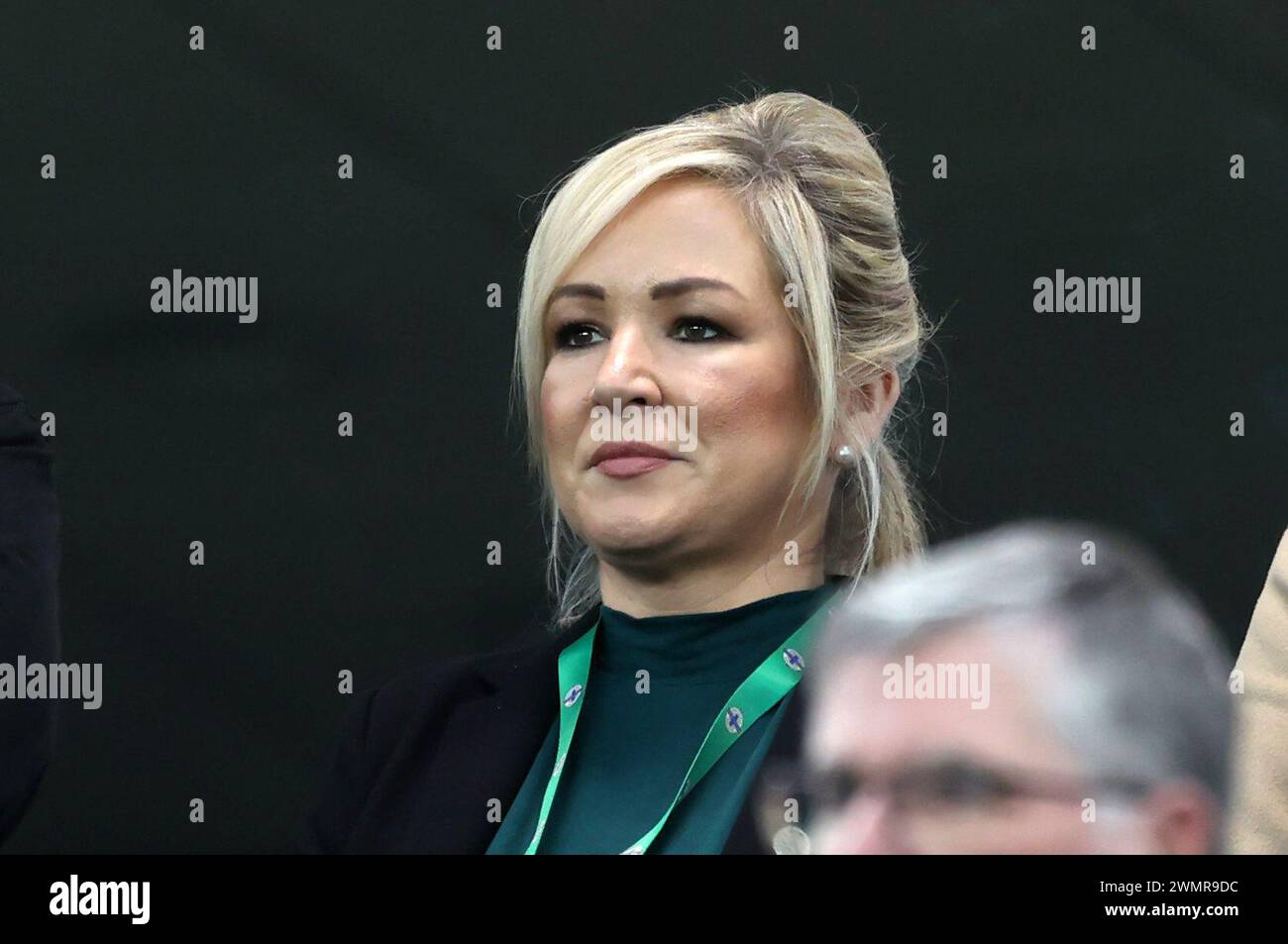 First Minister Michelle O'Neill stands for the national anthem before