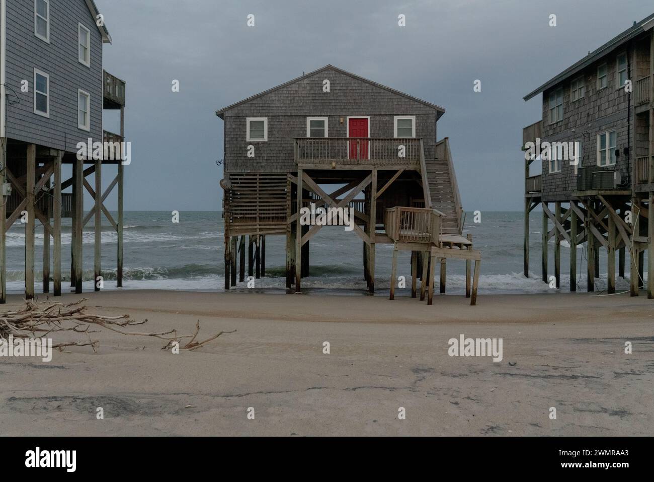 Houses crumble into the sea in Outer Banks due to some of the most rapid rates of coastal erosion and sea level rise on the East Coast, USA. Stock Photo