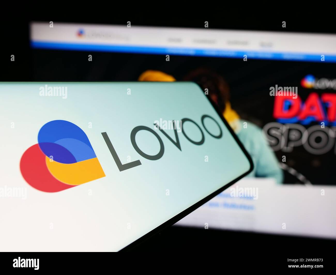 Mobile phone with logo of German online dating platform company LOVOO