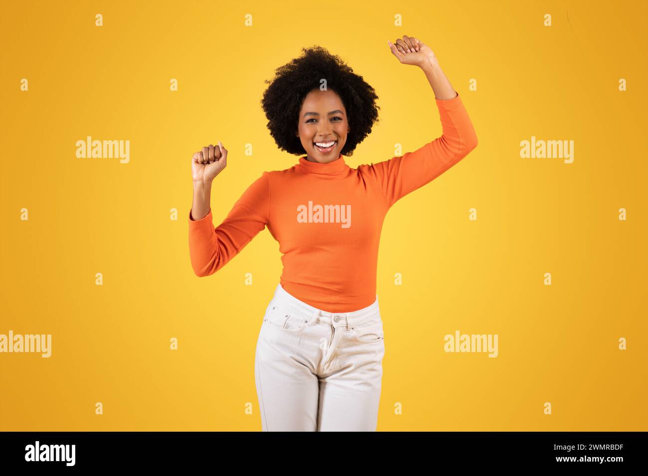 African american woman raises arms hi-res stock photography and images ...