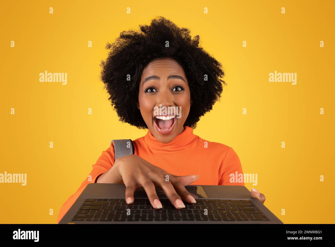 Excited black woman typing hi-res stock photography and images - Alamy