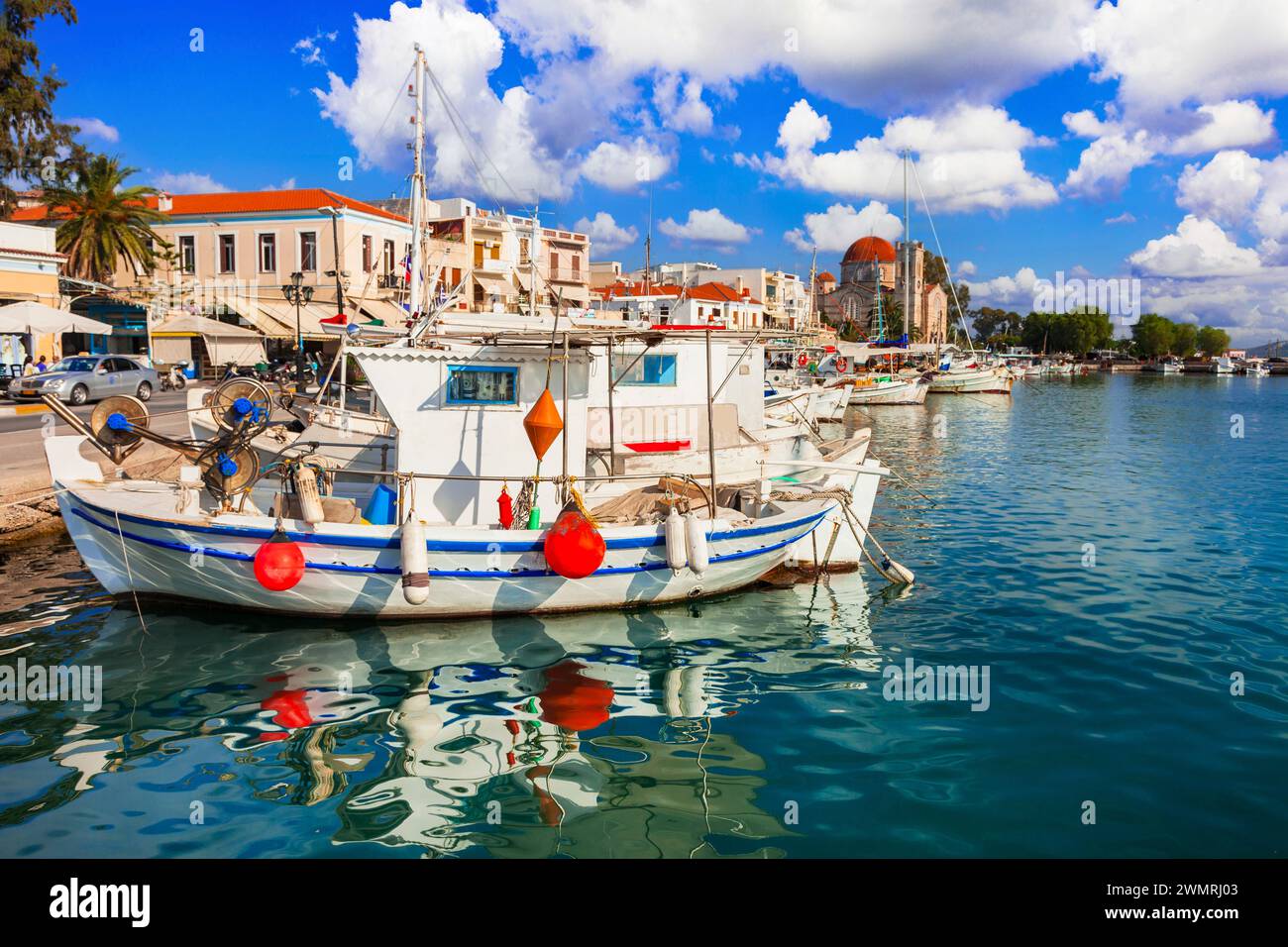 Saronics islands of Greece . Charming beautiful Greek island -Aegina with traditional fishing boats and St. Nicholas Church Stock Photo