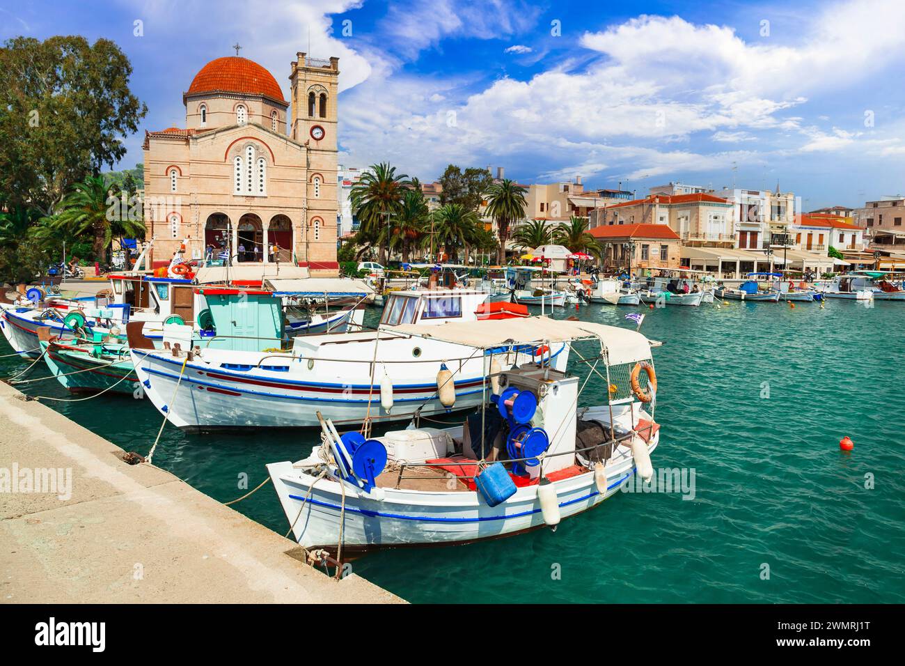 Saronics islands of Greece .Authentic beautiful Greek island -Aegina with traditional fishing boats and St. Nicholas Church Stock Photo