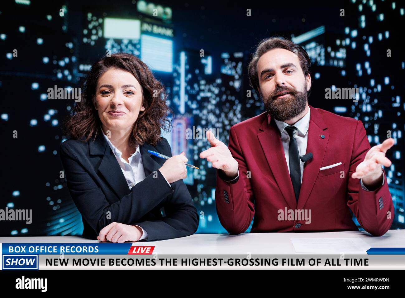 Newscasters team reveal new movie premiere breaking box office records, broadcasting live on midnight talk show. Presenters discussing about successful film winning awards, newsroom. Stock Photo