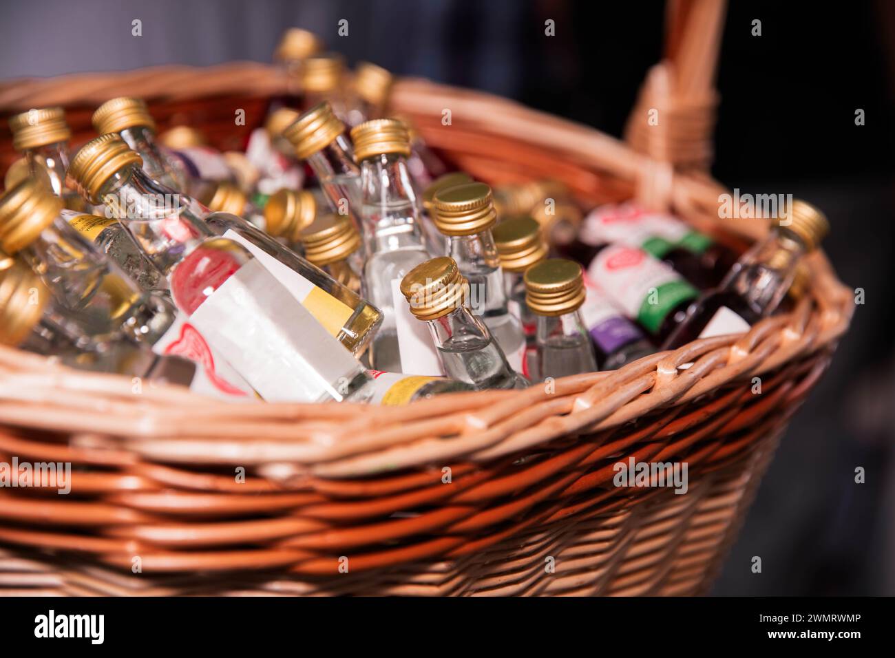 A variety of small liquor bottles displayed in a basket Stock Photo