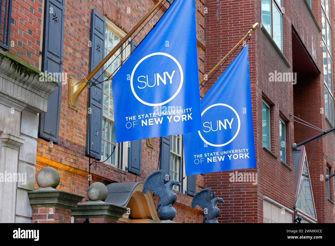 SUNY State University of New York flags adorning the exterior of the SUNY Welcome Center, 116 E 55th St, New York City. Stock Photo