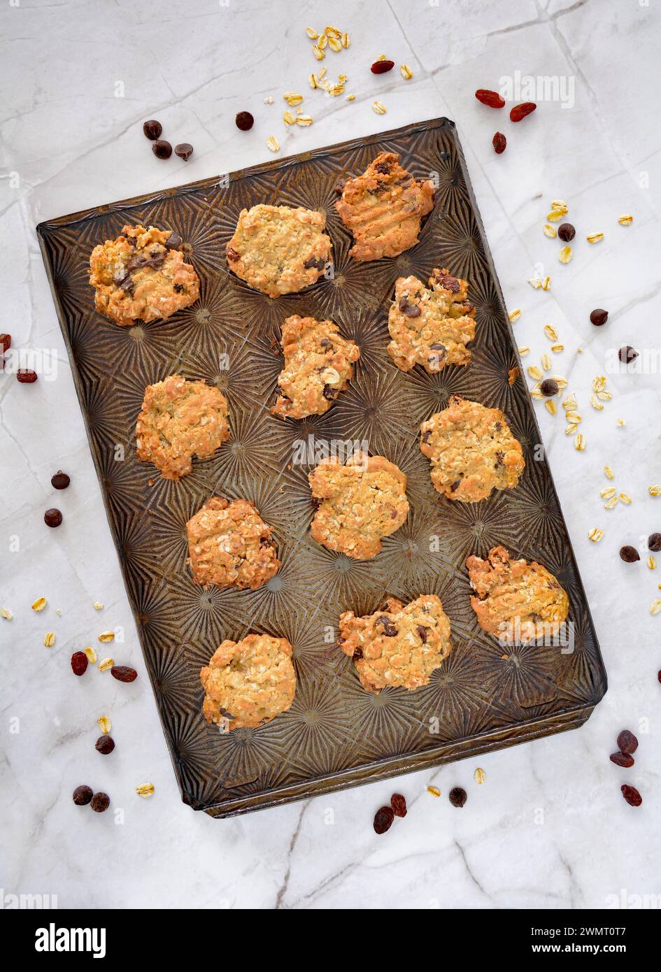 Homemade oatmeal, raisin, chocolate chip cookie bites on vintage cookie sheet in flat lay composition.  Healthy nutritious snack Stock Photo