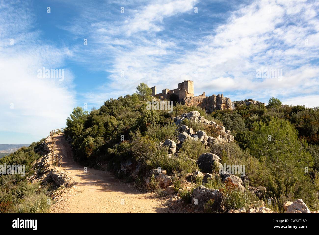 View of the path that leads to the castle of Chirel on a sunny morning. Cortes de Pallas - Valencian Community - Spain Stock Photo