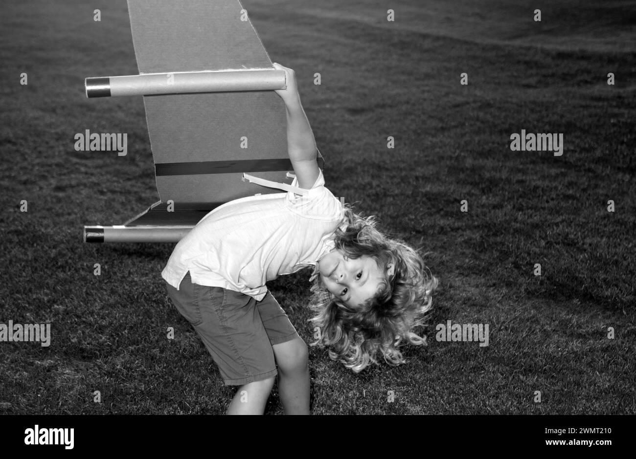 Funny child dreams of a rocket pilot. Imagination and