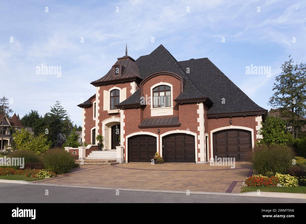 Luxurious two story red brick home with three car garage, paving stone ...