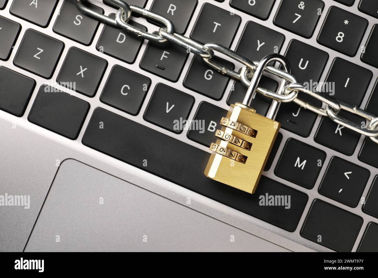 Cyber security. Padlock with chain on laptop, top view Stock Photo