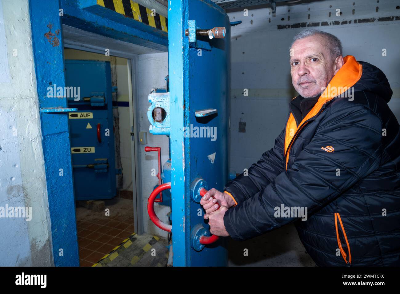 Pasewalk, Germany. 23rd Feb, 2024. Heinz Fuhrmann, owner from Torgelow, opens his bunker. According to owner Fuhrmann from Torgelow, there are several interested parties for the bunker for sale. The GDR bunker in Pasewalk is to be sold. Credit: Stefan Sauer/dpa/Alamy Live News Stock Photo