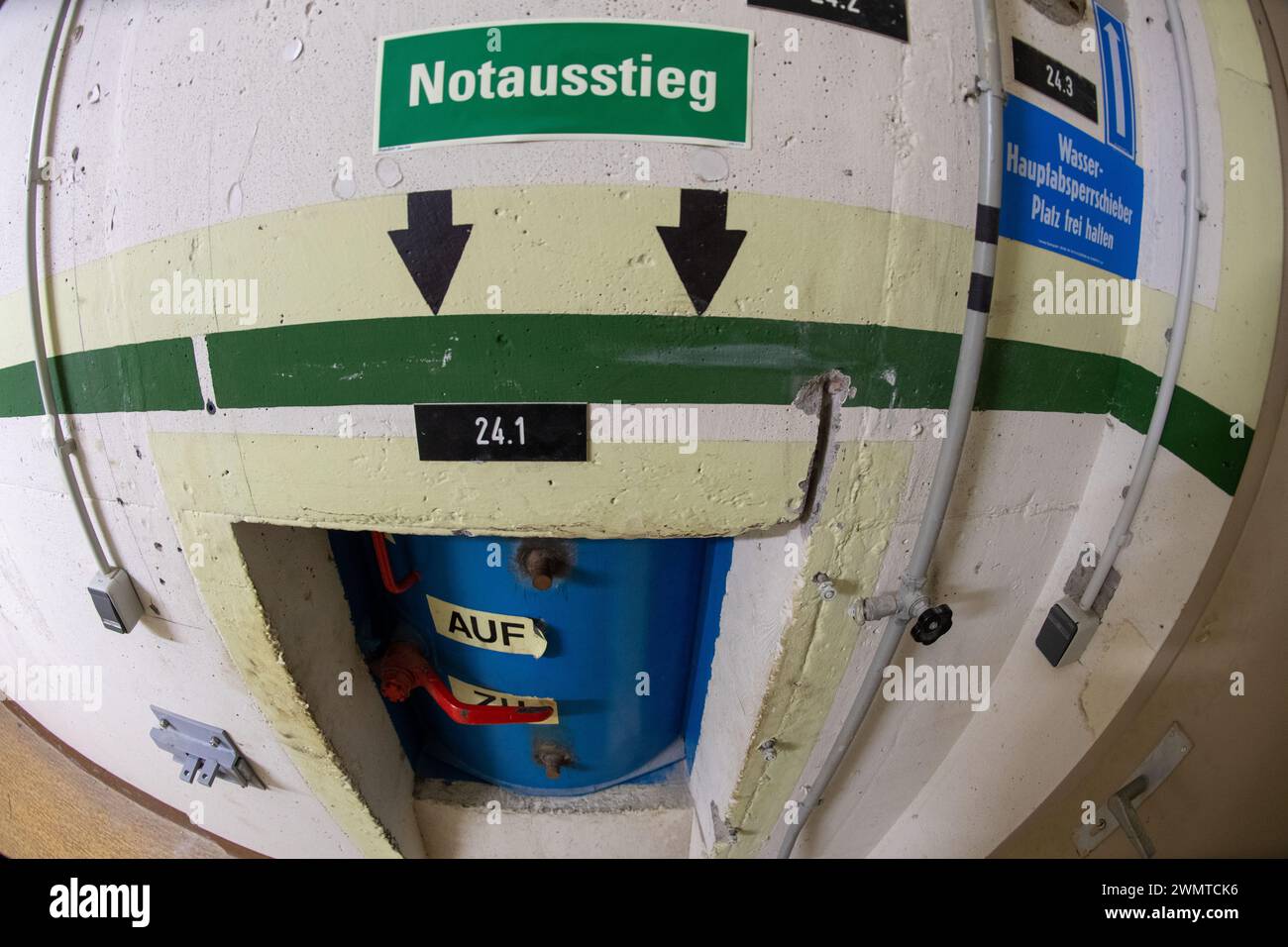 Pasewalk, Germany. 23rd Feb, 2024. A sign shows the emergency exit from the underground bunker. According to owner Fuhrmann from Torgelow, there are several interested parties for the bunker for sale. The GDR bunker in Pasewalk is to be sold. Credit: Stefan Sauer/dpa/Alamy Live News Stock Photo