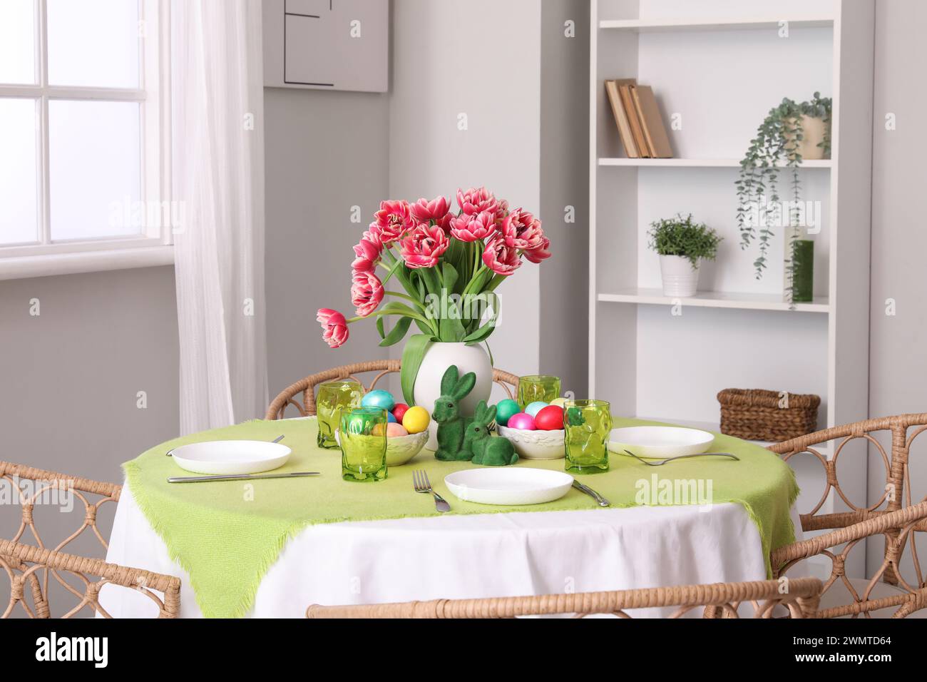 Beautiful table serving for Easter celebration in light dining room Stock Photo