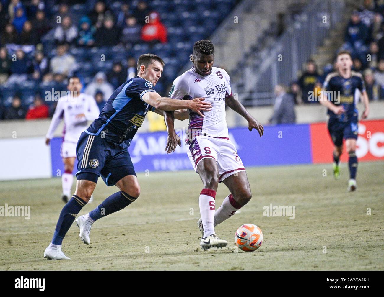 Chester, Pennsylvania, USA. 27th Feb, 2024. February 27, 2024, Chester PA, USA: Deportivo Saprissa player, FIDEL ESCOBAR (21) fights for the ball with Philadelphia Union player, MIKAEL UHRE (7) Union at the 2024 Concacaf Champions Cup Round One at Subaru Park. The Union won on aggregate points to move into the round of 16. Credit Image: © Ricky Fitchett via ZUMA Wire (Credit Image: © Ricky Fitchett/ZUMA Press Wire) EDITORIAL USAGE ONLY! Not for Commercial USAGE! Stock Photo